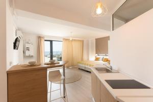 a kitchen and living room with a bed in the background at Milena in Mamaia Sat/Năvodari