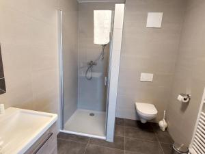 a bathroom with a shower and a toilet and a sink at Apartment Lilie by Interhome in Velden am Wörthersee