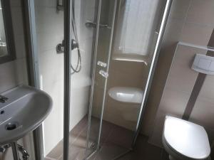 a bathroom with a shower and a toilet and a sink at Apartment Lilie by Interhome in Velden am Wörthersee