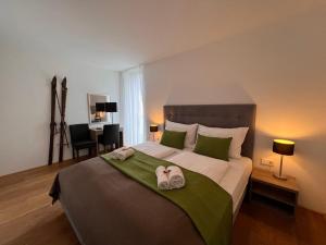 a bedroom with a large bed with towels on it at Apartment Residence Bellevue by Interhome in Zell am See