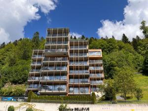 a tall apartment building with trees in the background at Apartment Residence Bellevue by Interhome in Zell am See