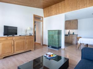 a living room with a couch and a tv at Apartment Hotel Restaurant La Tgoma by Interhome in Lenz