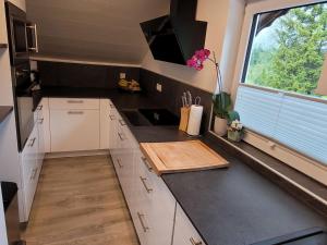 a kitchen with white cabinets and a window and a counter at Apartment Lercher by Interhome in Seefeld in Tirol