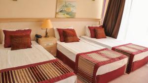 une chambre d'hôtel avec deux lits et une lampe dans l'établissement Cashmere Hotel, à Kusadası