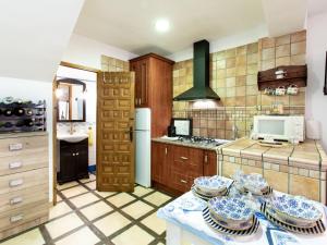 a kitchen with a table with plates on it at Holiday Home Elvira by Interhome in Nigüelas