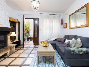 a living room with a blue couch and a fireplace at Holiday Home Elvira by Interhome in Nigüelas +17 photos