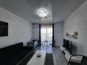 salon z kanapą i stołem w obiekcie Mamaia Apartament Bucurie & Liniste w mieście Năvodari