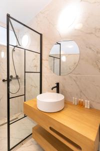 a bathroom with a white sink and a mirror at Milena in Mamaia Sat/Năvodari +19 photos