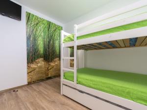 a bedroom with bunk beds and a tv at Apartment Rodas-5 by Interhome in Salou