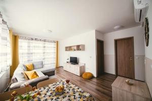 a living room with a couch and a table at D&B Lelle Apartman in Balatonlelle