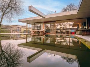 a house with a reflecting pool in front of it at Villa Domicile adoré by Interhome in Ostend