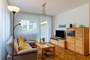 a living room with a couch and a tv at Streck in Bad Peterstal-Griesbach