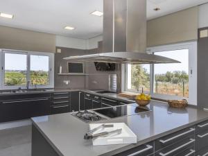 a kitchen with a large island with a counter top at Villa Finca Villa Roig by Interhome in Peniscola