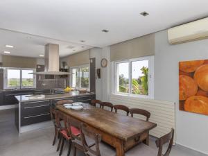 a kitchen with a wooden table and chairs at Villa Finca Villa Roig by Interhome in Peniscola