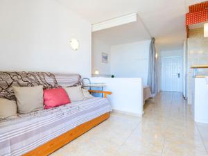a room with a couch with pillows on it at Studio Eurhostal - Seaview by Interhome in Alcossebre