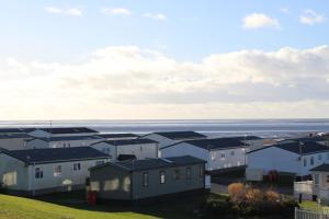 a group of houses with the ocean in the background at The Rivington Lodge in Heysham