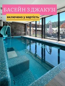 a swimming pool in a hotel with the words baghtar kkkkk at Korona Hotel&SPA in Bukovel
