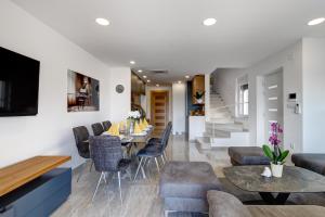 a dining room and living room with a table and chairs at Villa Zara in Dramalj