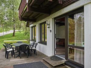 a patio with a table and chairs on a porch at Holiday Home Am Sternberg 18 by Interhome in Frankenau