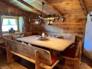 a dining room with a table and chairs in a cabin at Apartment Hüttaler by Interhome in Dorf