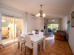 a dining room with a white table and chairs at Holiday Home Origin by Interhome in Olivella +40 photos
