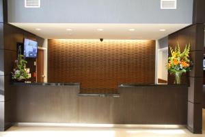 a lobby with a large wall with flowers on it at Wingate by Wyndham Niagara Falls in Niagara Falls