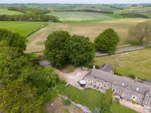 an aerial view of an old house in a field at Bill's Cottage in Northleach