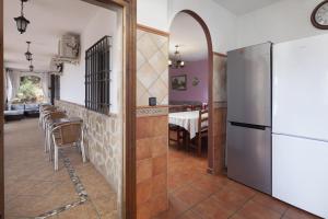 a kitchen with a refrigerator and a dining room at Casa Rural Los Hidalgos in Tolatán