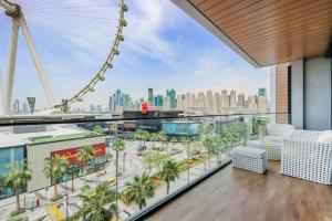a view of the london eye from the top of a building with a balcony at Bluewater Island - Bright 2 BR Suite with Dubai Eye View by Livbnb in Dubai
