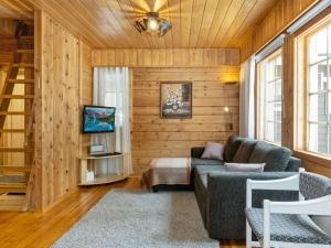 a living room with a couch and a bed at Holiday Home Susitupa 5 by Interhome in Salla