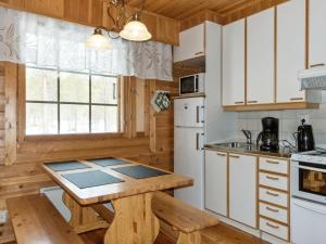 uma cozinha com armários de madeira e uma mesa de madeira em Holiday Home Susitupa 5 by Interhome em Salla