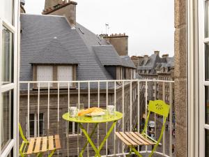 a balcony with a table with a sandwich and two chairs at Apartment Plasenn by Interhome in Saint Malo