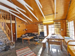 a living room with a couch and a table at Holiday Home Harvana by Interhome in Kittilä