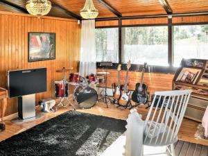a living room with a bunch of instruments in it at Holiday Home Pippuriranta by Interhome 