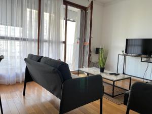Televízia a/alebo spoločenská miestnosť v ubytovaní Appartement T5 standing 104m2