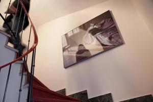 a picture hanging on a wall next to a staircase at Maratscher Kunst & Kulturhotel in Lagundo