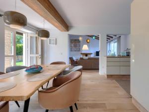 a kitchen and dining room with a wooden table and chairs at Holiday Home Villa Anita by Interhome in Momjan