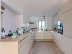 a kitchen with white cabinets and a counter top at Holiday Home Villa Anita by Interhome in Momjan
