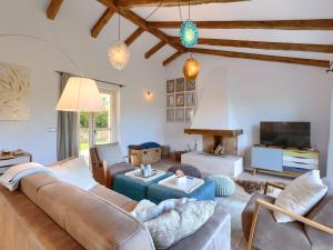 a living room with a couch and a tv at Holiday Home Villa Anita by Interhome in Momjan +36 photos
