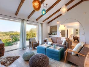 a living room with a couch and a table at Holiday Home Villa Anita by Interhome in Momjan
