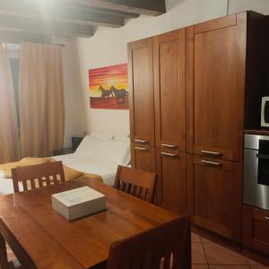a kitchen with a dining room table and a bedroom at Appartamento centro Lecco in Lecco