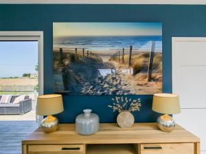 a living room with two lamps on a wooden dresser at Holiday Home Maison du Venec by Interhome in Santec