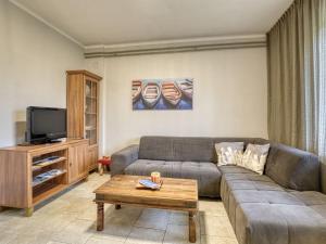 a living room with a couch and a tv at Apartment Ani by Interhome in Kastav