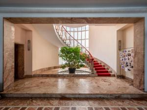 a staircase in a building with a potted plant at Holiday Home Casa Giacomelli by Interhome in Mathi