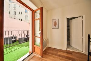 een kamer met een balkon en een glazen schuifdeur bij 12.Appartement 4Pers#Sèvres-Lecourbe#Necker in Parijs
