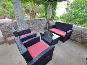 a patio with two chairs and a table and a bench at Holiday Home Micheli by Interhome in Gornji Humac