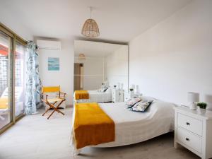 a bedroom with two beds and a large mirror at Apartment Le Montcey by Interhome in Cagnes-sur-Mer