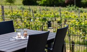 a wooden table with chairs and two candles on it at Weingut J. A. Meyer in Wintrich