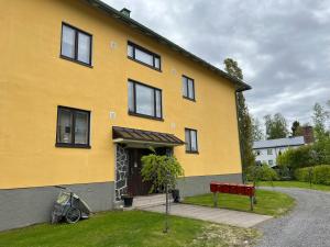 a yellow house with a bike parked in front of it at Apartment Huvilakatu in Kokkola