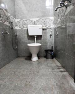 a bathroom with a toilet and a shower stall at Tulsi Authentic Homestay - Beach Village Goa in Canacona